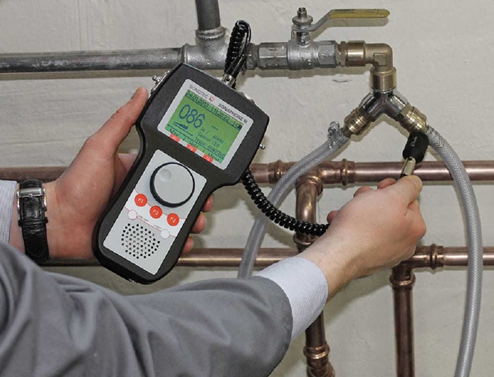 Plumber testing pipes with electronic leak detection equipment in Lehigh Acres