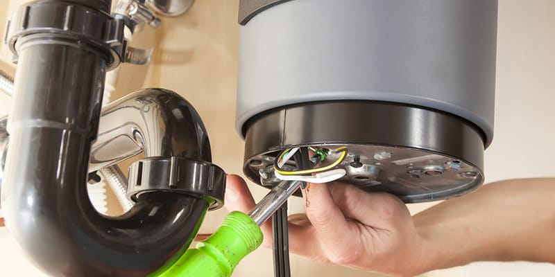 Technician repairing the heating element of a water heater in Lehigh Acres