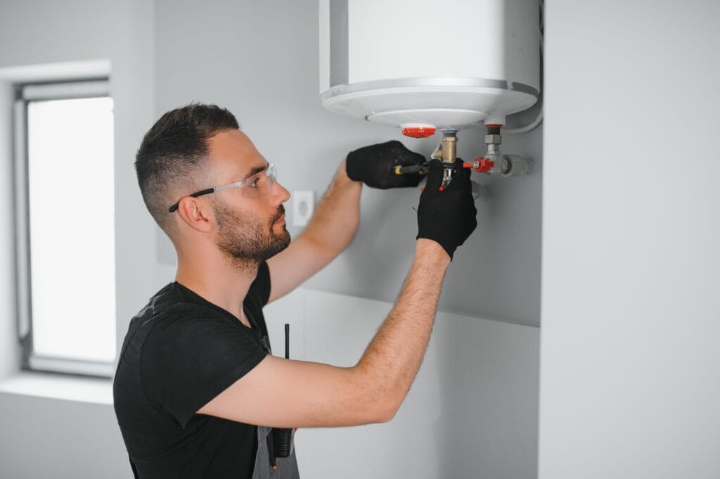 Technician performing water heater maintenance in Lehigh Acres